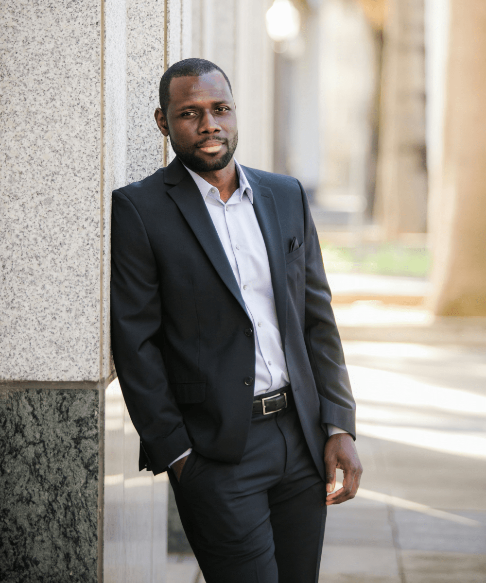 Business man leaning on building